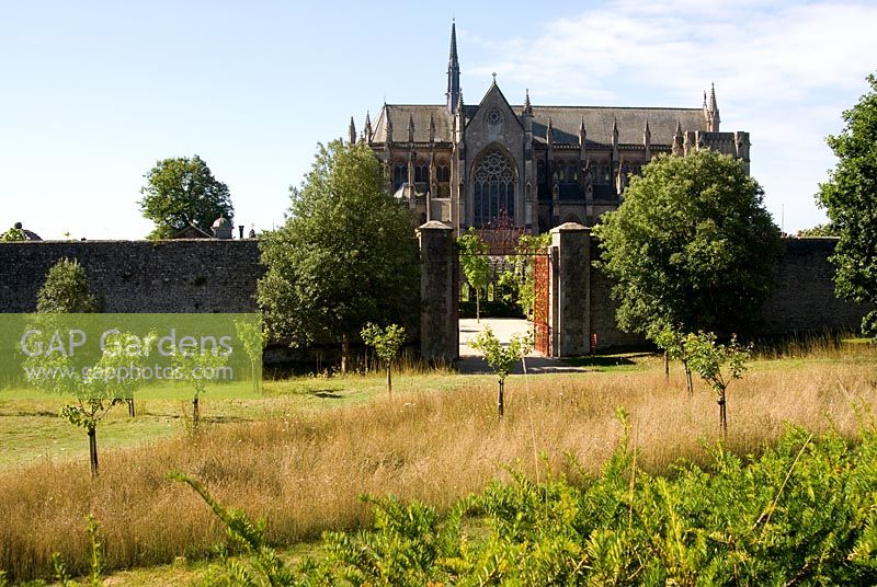 Gates into the Collector Earl's Garden designed by Julian and Isabel Bannerman, with the dramatic backdrop of Arundel Cathedral behind.