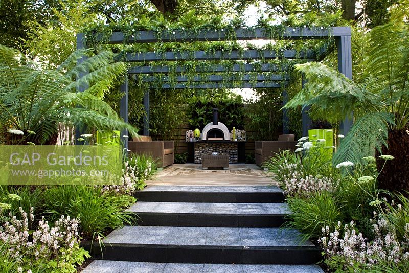 Lush planting to a raised deck and a living pergola. Tree ferms predominate - 'Live Outdoors' - Silver gilt medal winner - RHS Hampton Court Flower Show 2012  