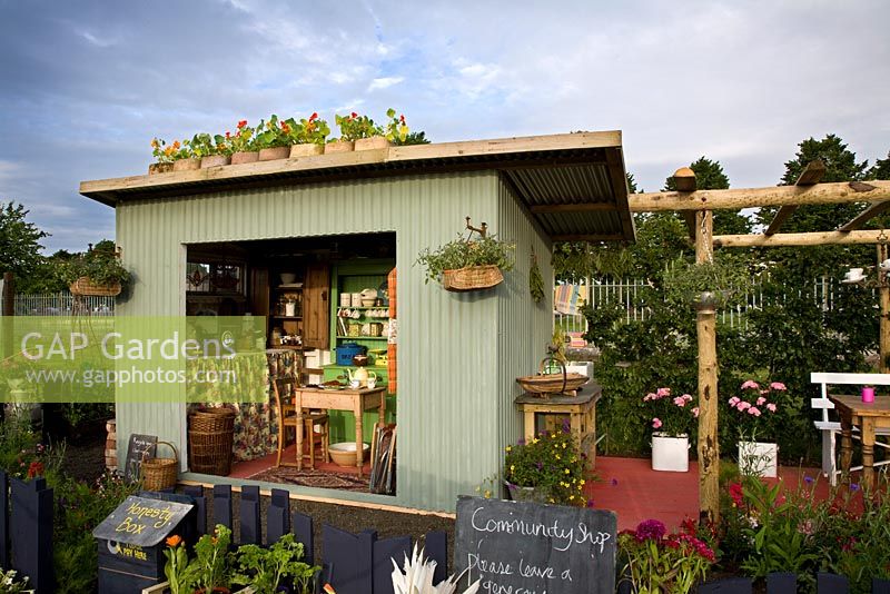 An old tin field shelter has been converted into a preserving kitchen - 'Preserving the Community' - Silver medal winner - RHS Hampton Court Flower Show 2012 
