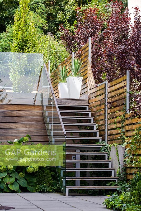 Modern stairway leading up to raised garden