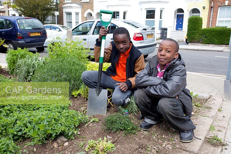 Two young boys with spade. Edible Bus Stop.