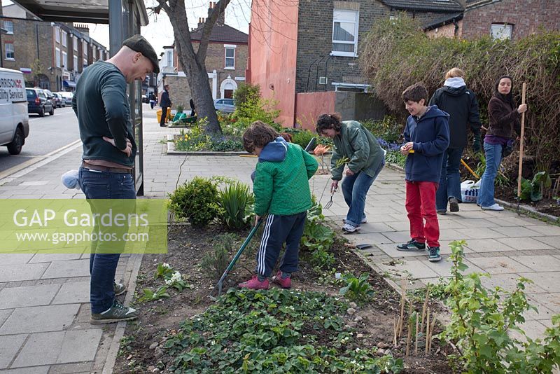 Adults and children working at the Edible Bus Stop