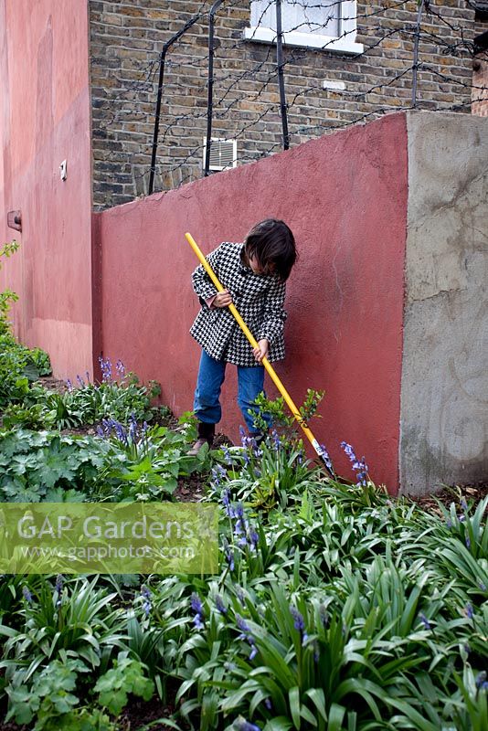 Child tidying border at the Edible Bus Stop