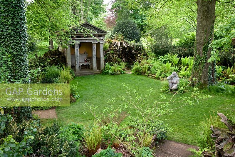 The Stumpery with the sculpture 'Goddess of the Woods' and one of two temples - Highgrove Garden, May 2008.