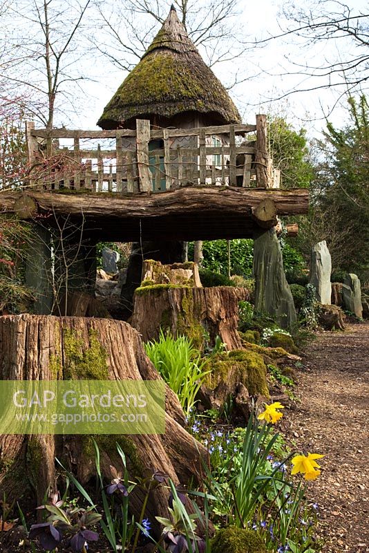 The thatch tree house 'Hollyrood House', The Stumpery, Highgrove Garden, March 2011. The Stumpery is based on a Victorian concept for growing ferns amongst tree stumps.  