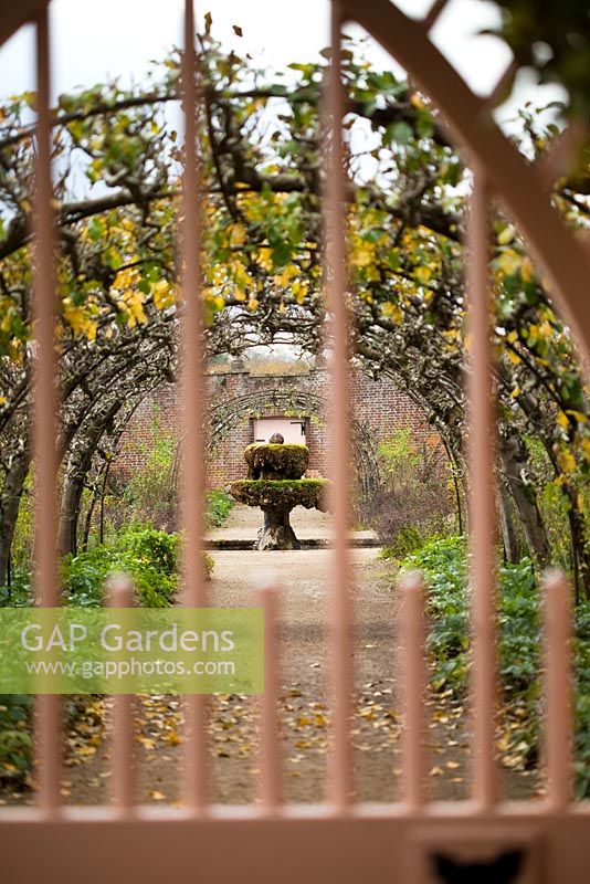 The Walled Garden and water feature seen through a gate, Highgrove Garden, November 2010