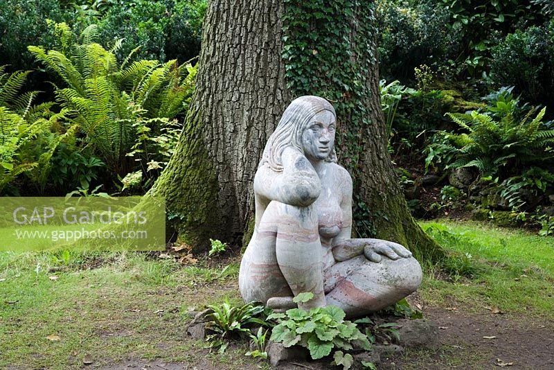 Sculpture of a Wood Nymph (Goddess of the Woods) sits in the meditative pose, in the Stumpery. Highgrove Garden, August 2007.