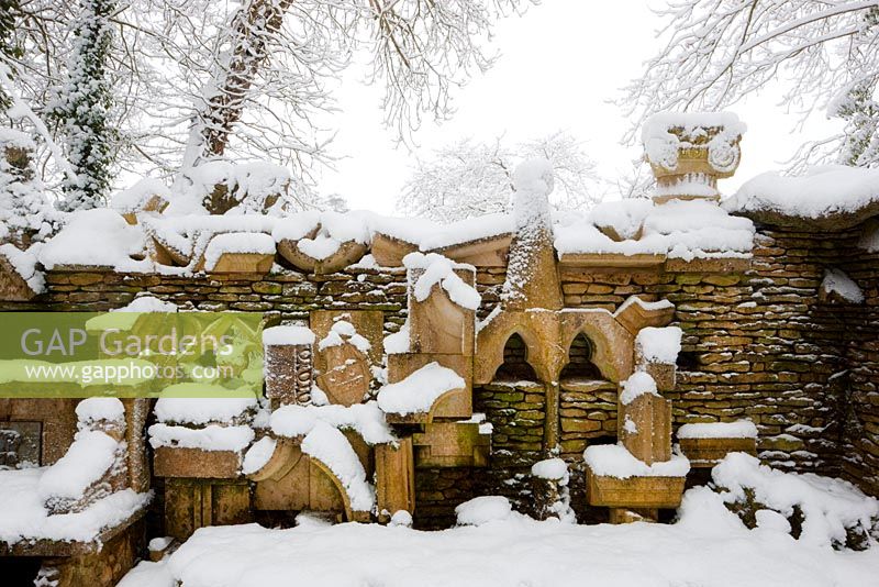 The Wall of Gifts, in the Stumpery, covered in snow at Highgrove Garden, January, 2010. The wall of gifts consists of various pieces of architectural stone, some given to The King and some collected by him. 