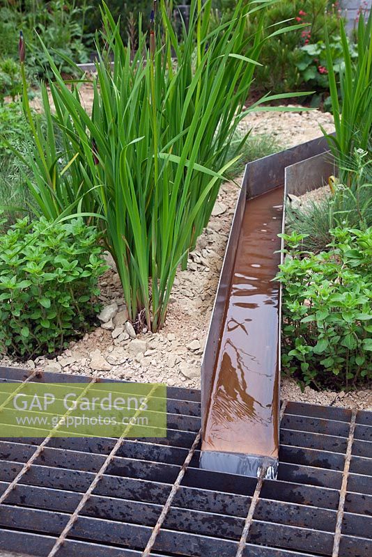 Irrigation channels cross the Climate Calm Garden at the RHS Chelsea Flower Show 2012