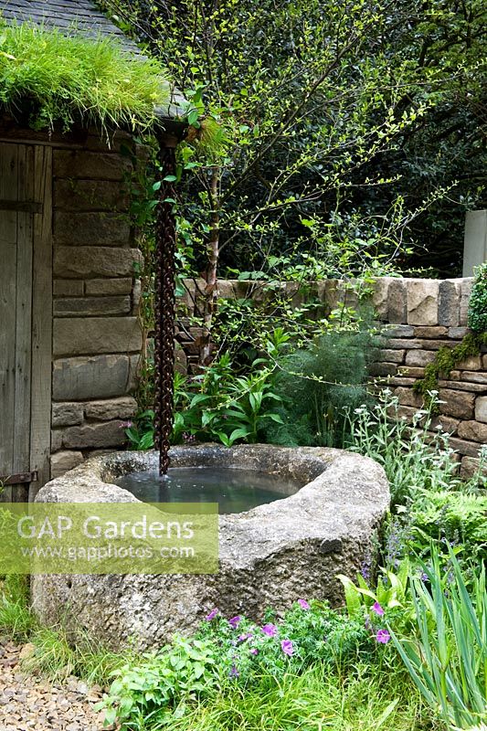 Well of water in front of stone crofter's hut - Naturally Dry, a William Wordsworth-inspired garden for Veolia. RHS Chelsea Flower Show 2012. Silver Flora medal winner