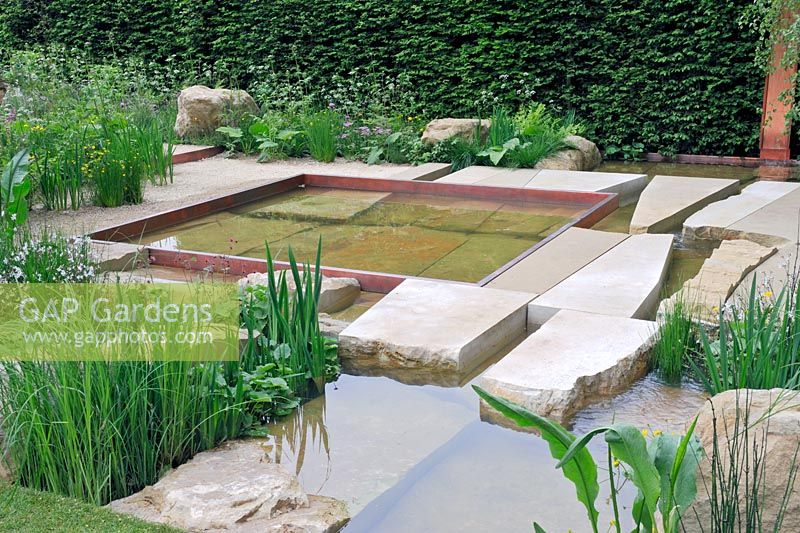 The Telegraph Garden, Gold Medal winner, RHS Chelsea Flower Show 2012. Stepping stones and large boulders in semi wild water garden
 
