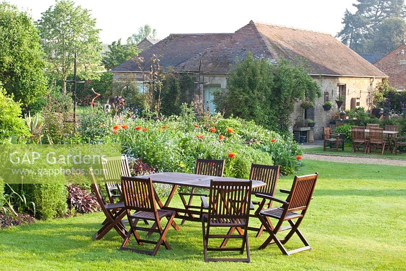 The Manor House - outdoor dining table and chairs on lawn 