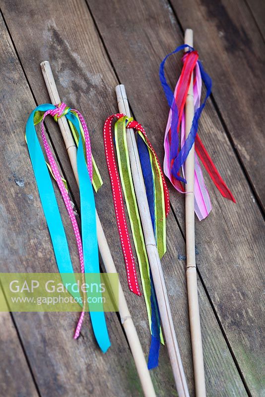 Making garden tealight holders - Tie colourful lengths of ribbon around the elastic bands