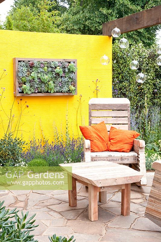 Mediterranean terrace with furniture made from recycled pallets
