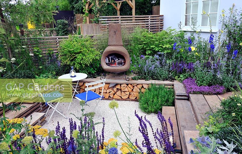 Sunken garden with chiminea and reclaimed scaffolding boards used as decking. Our First home Our first garden, Hampton Court Palace  flower show 2012