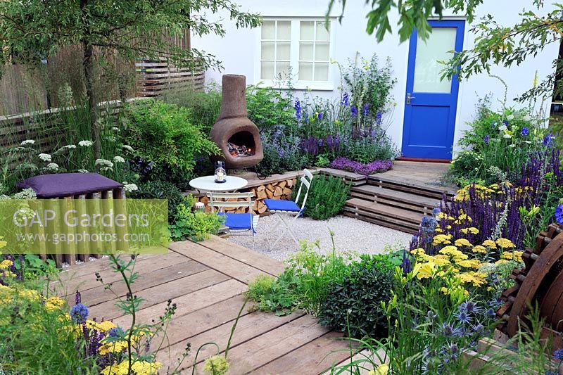 Sunken garden with chiminea fireplace with reclaimed scaffolding boards used as decking. Our First home Our first garden, Hampton Court flower show 2012