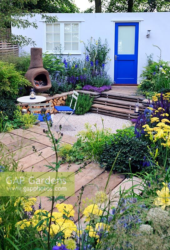 Sunken garden with chiminea fireplace with reclaimed scaffolding boards used as decking. Our First home Our first garden, Hampton Court flower show 2012