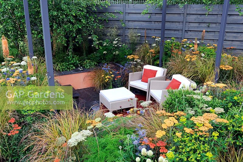 Sunken seating area in urban garden with shade structure, 'The Landform graden', Hampton Court Palace flower show 2012