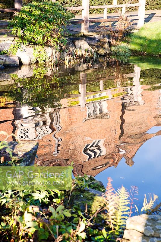 Grade II listed building reflected in moat - Great Fosters, Surrey 