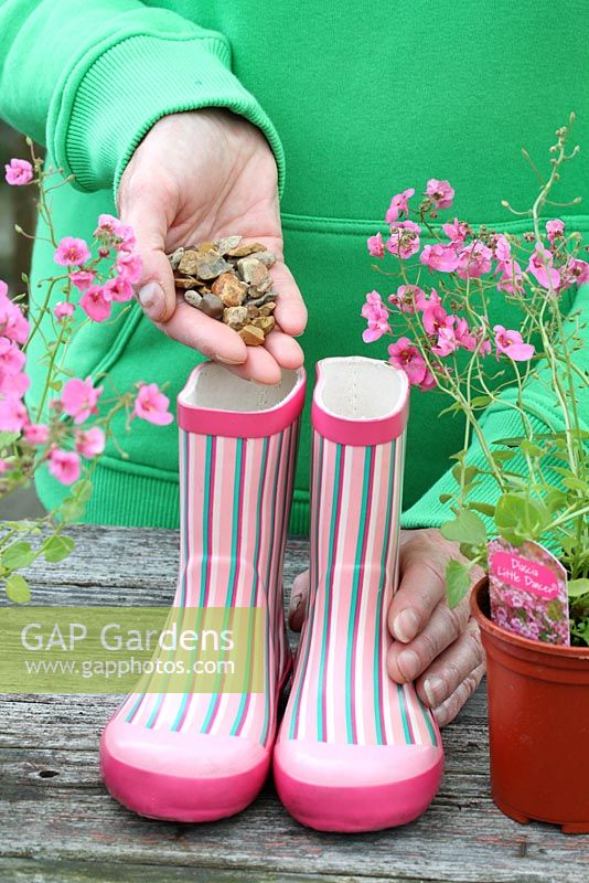 Step by step of planting a pair of recycled kids wellies with Diascia 'Little Dancer' - Adding gravel to base of boot to help with drainage