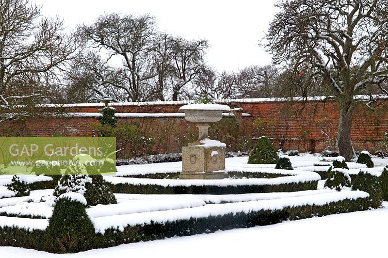 Walled garden with parterre and large stone ornament - in winter 