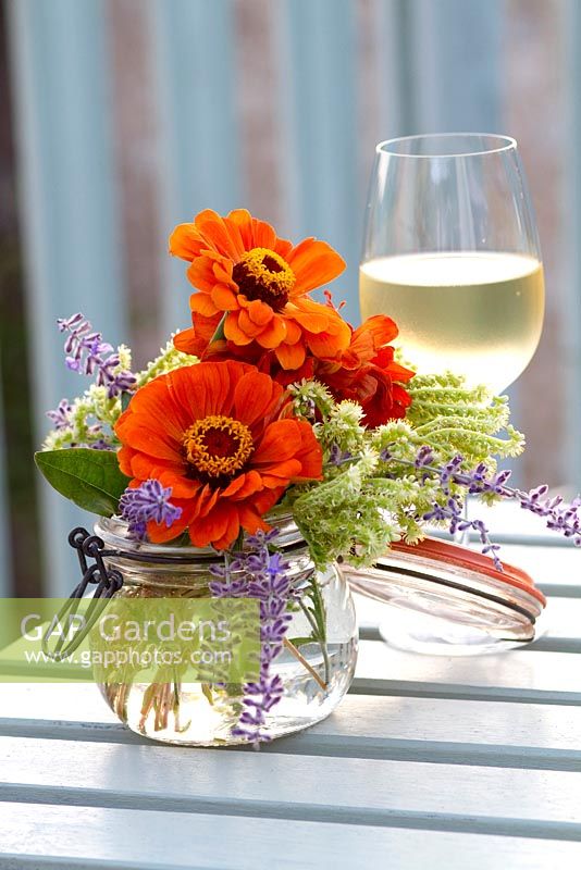 Bouquet of Zinnia and glass of white wine