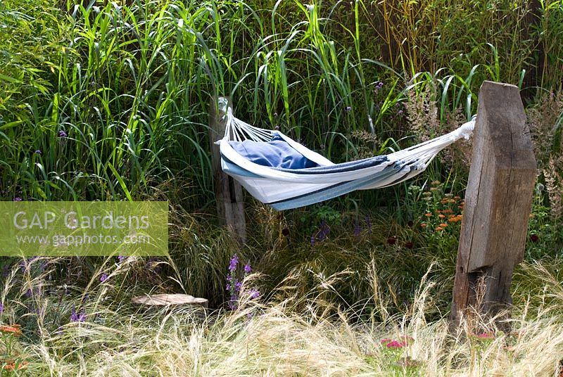 Hammock surrounded by ornamental grasses in the 'One Man Went To Mow' garden, RHS Tatton Flower Show 2012