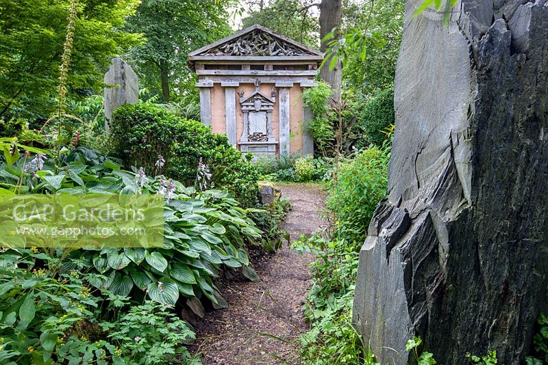 Welsh slate and Green Oak Temple in the Stumpery, Highgrove Garden, August 2012. The Stumpery is based on  a Victorian concept for growing ferns amongst tree stumps.  