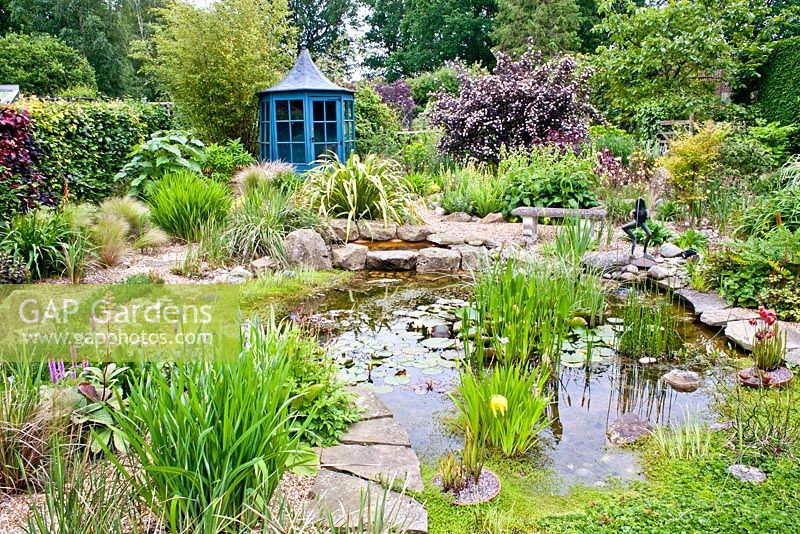 Pond area with gravel planting and blue painted gazebo