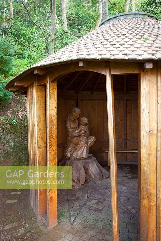 Sculpture of Madonna and child in the wooden chapel at Greencombe Gardens, Somerset