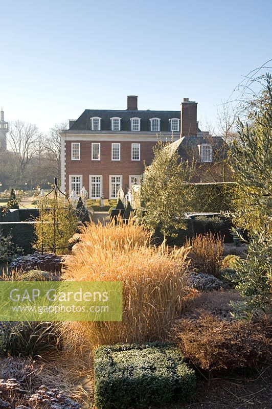 Formal garden in winter with Sedum, Calamagrostis acutiflora, clipped Buxus - Winfield House
