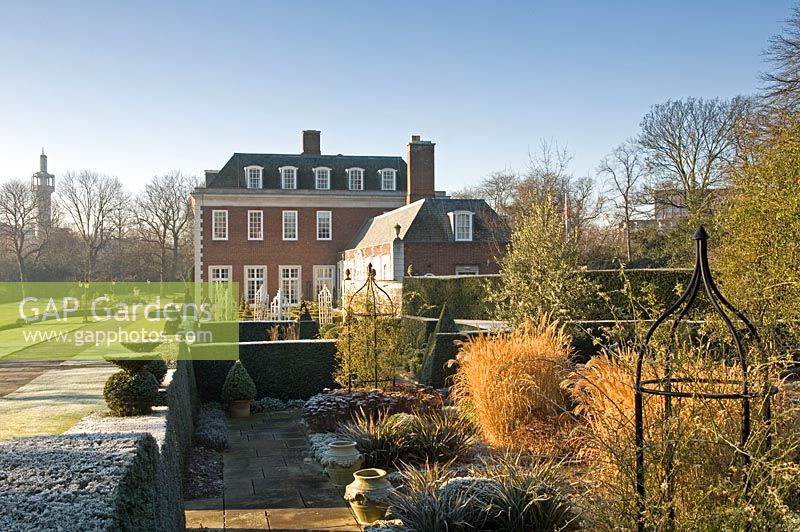 Formal garden in winter with Sedum, Calamagrostis acutiflora, clipped Buxus and hedging - Winfield House 