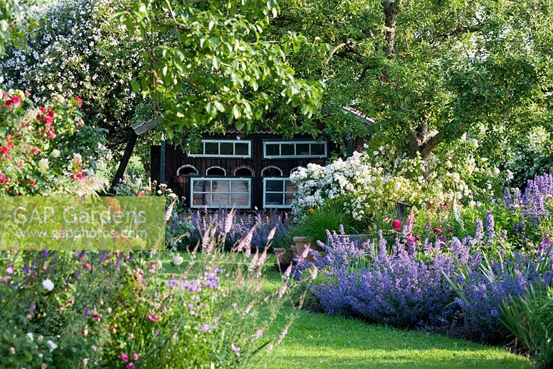 A Bavarian country garden with perennial borders and climbing roses