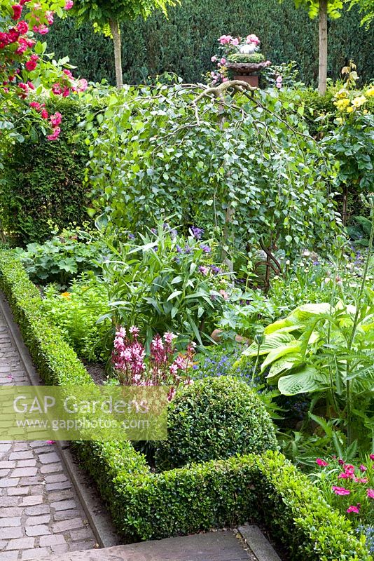 Mixed borders surrounded by clipped box hedging
 
