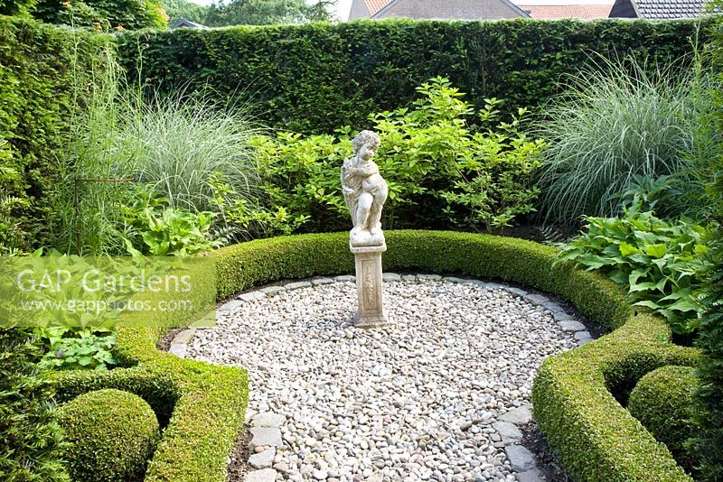 Small formal garden with statue as focal point