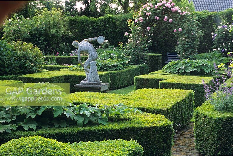 Formal garden with clipped box hedges and figurative statue