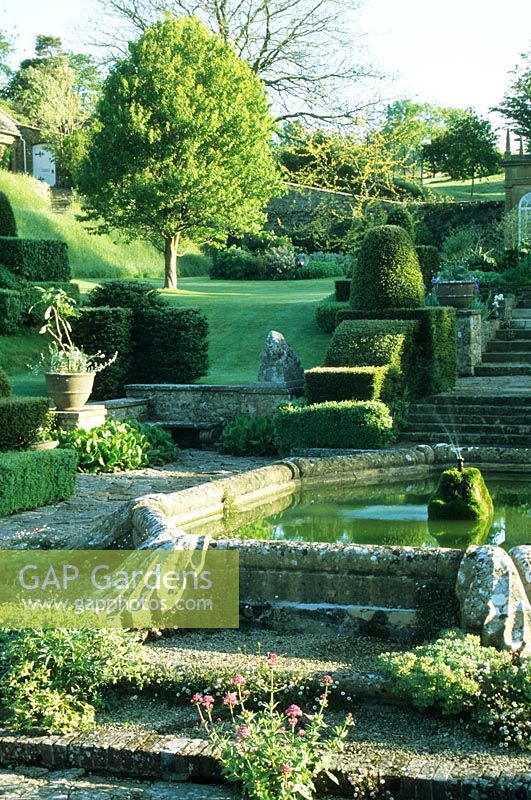 View across Fountain Court with pergola. - Mapperton Garden, Beaminster, Dorset, UK. May. 