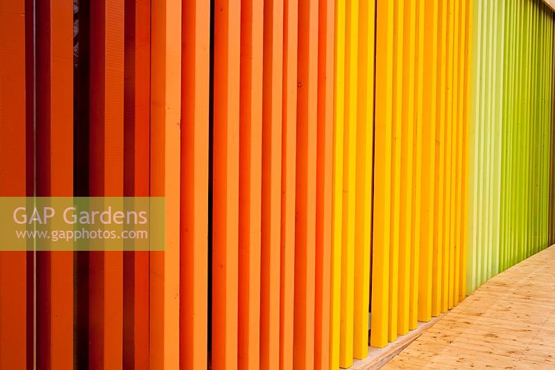 Wooden rainbow fence with decking on Spanish pavilion 