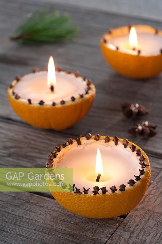 Making candles - Candles in orange skin decorated with cloves 
