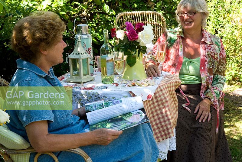 Women enjoying conversation and a glass of wine in the garden