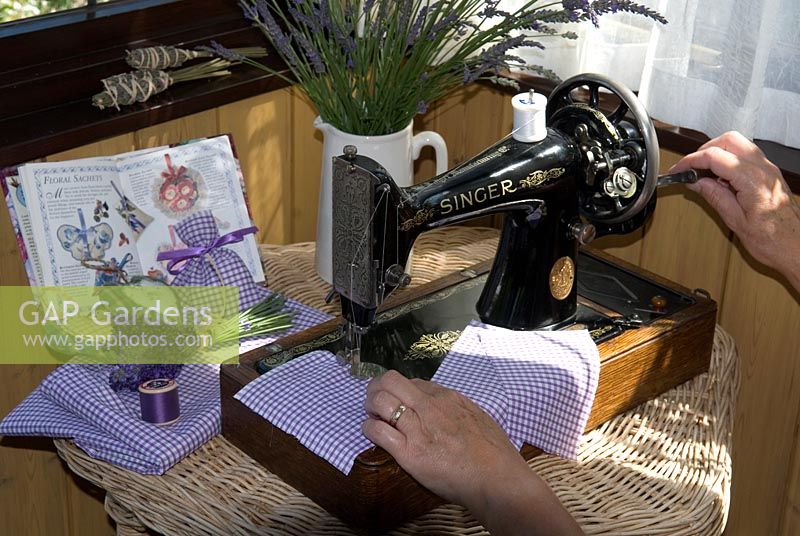 Woman using sewing machine to make lavender sachets