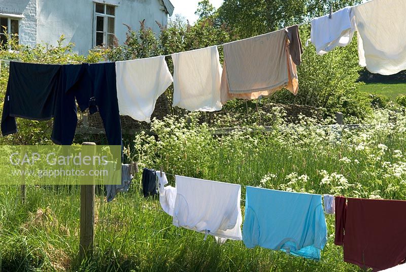 Washing drying on line and fence in garden of country cottage