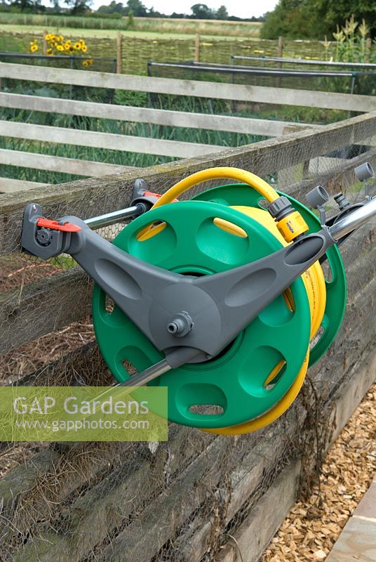 Garden hose on reel, fixed to vertical fence for ease of use - Bays Farm NGS, Forward Green, Suffolk