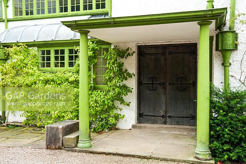 Porch over the north facing front door, with all exterior wood and metalwork painted in Voysey green. House dated 1895. Perrycroft, Upper Colwall, Herefordshire, UK