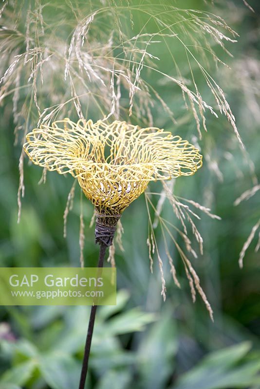 Bird feeder made from chicken wire and shaped like a flower 