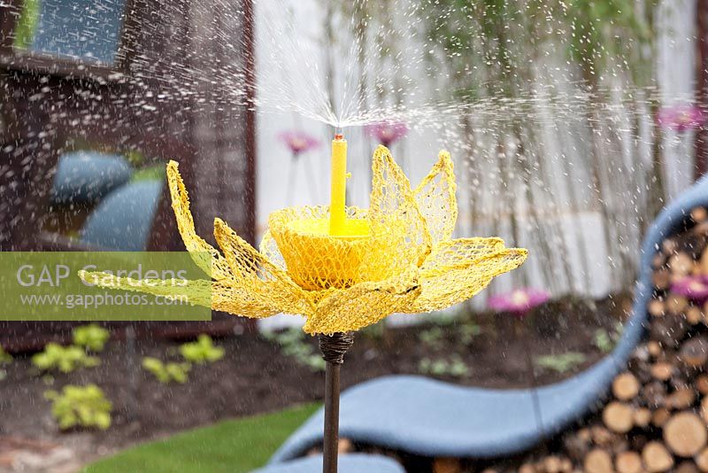 Water sprinkler made from chicken wire and shaped like a giant flower