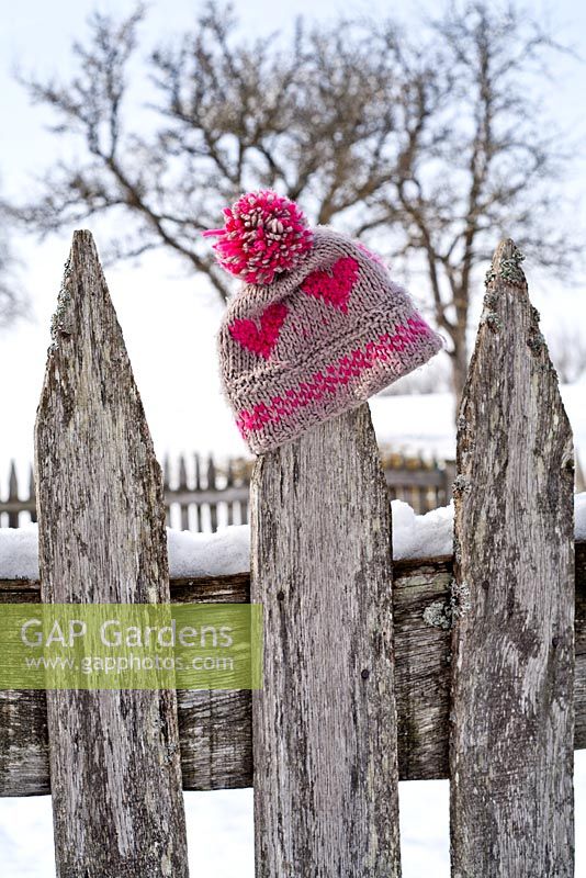 Bobble hat on wooden fence