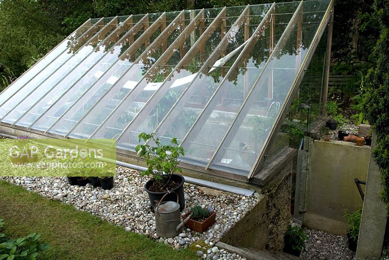 Sunken greenhouse, with extensive glass roof and steps leading down to entrance - Open Gardens Day 2012, Westleton, Suffolk