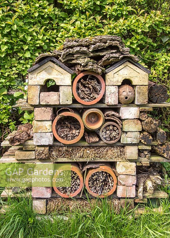 Insect house composed of brick, terracotta and wood