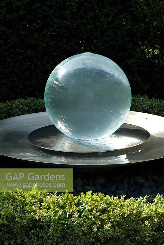 Glass ball fountain with a low Buxus hedge in June - Richard Ayres' Garden